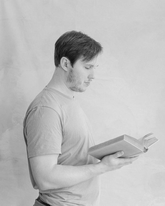 Black and white photo of me, the owner, reading a book.